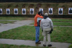 Teacher and student line up the sights at the firing range.